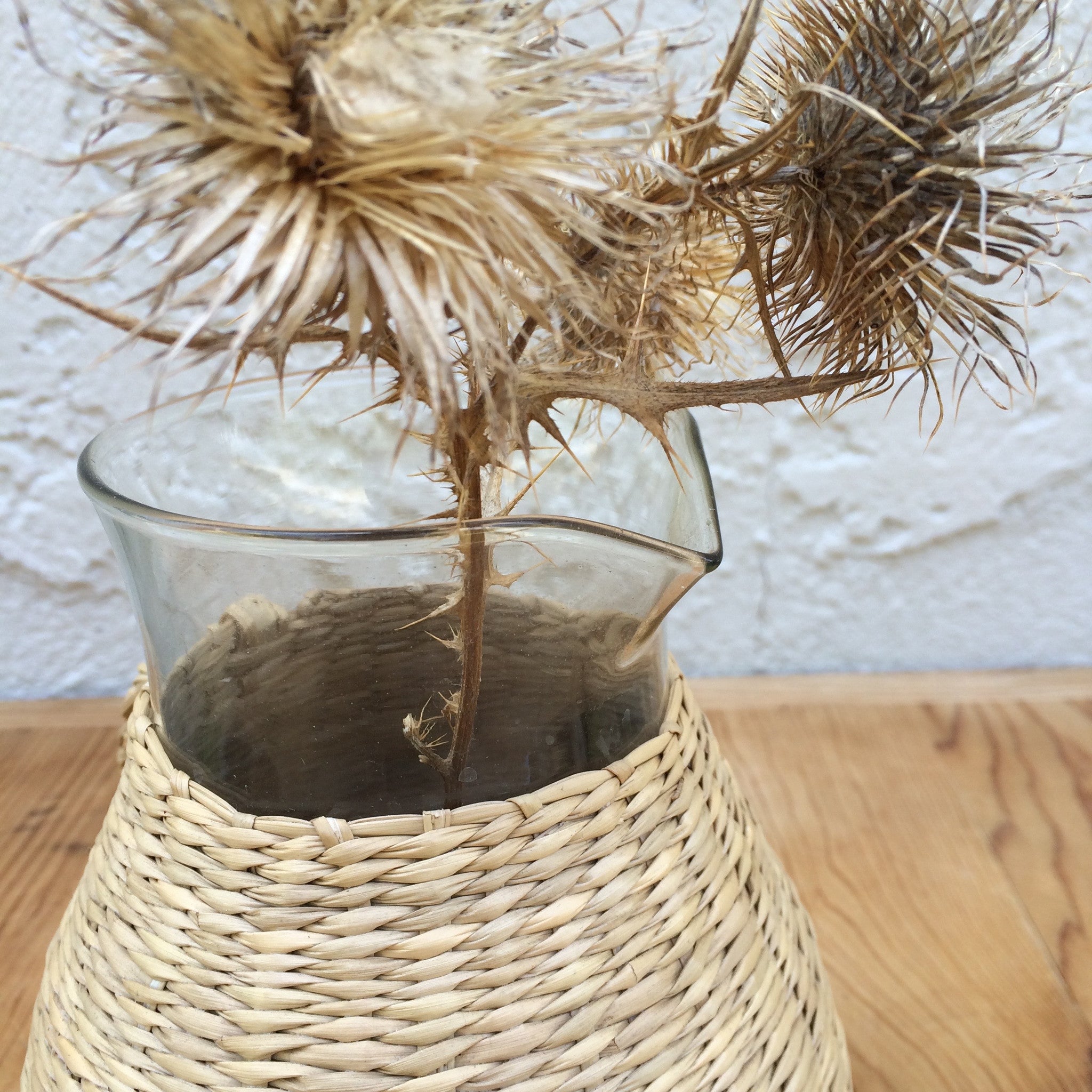 wicker and glass pitcher